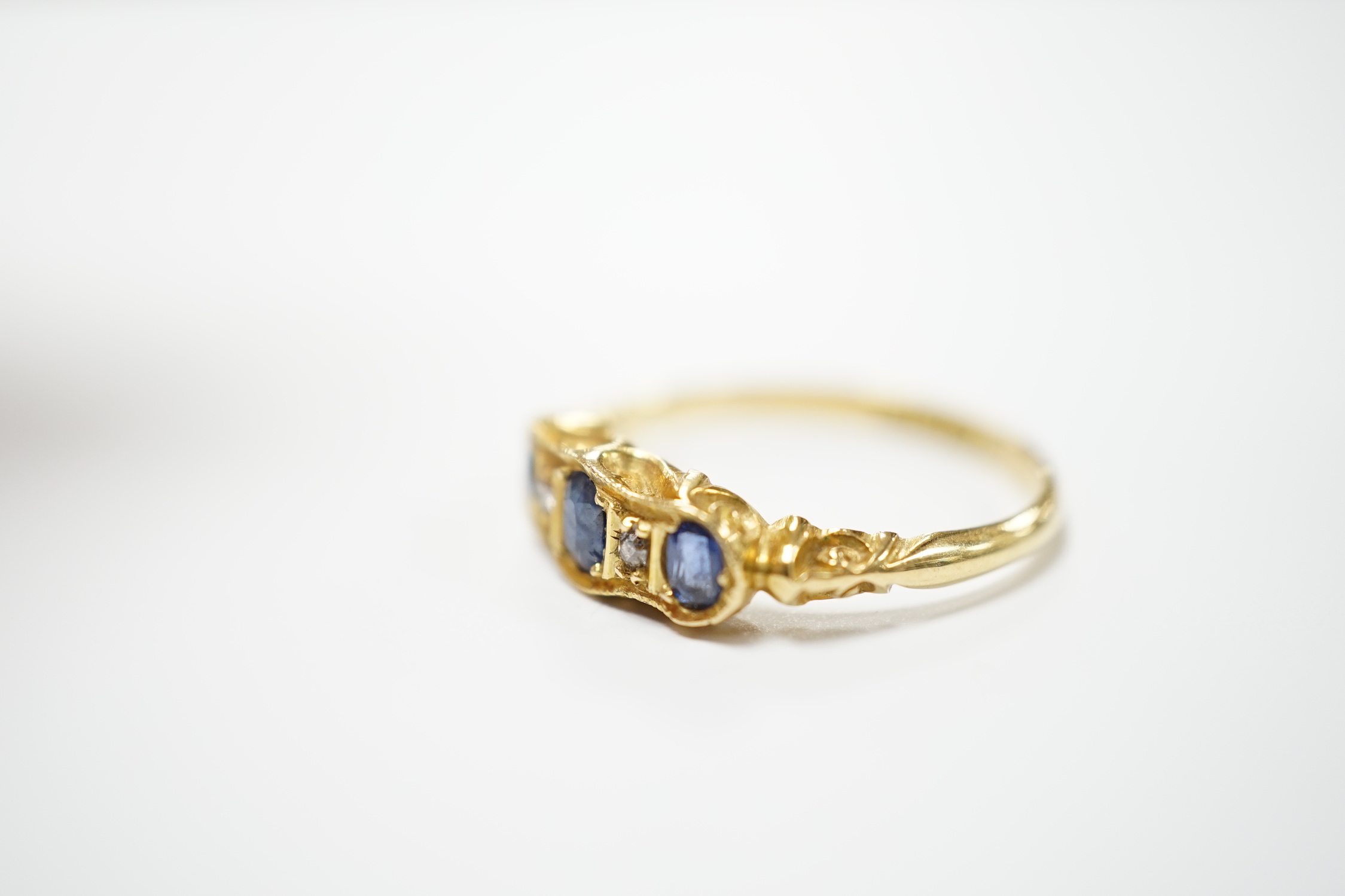 A late Victorian 18ct gold, sapphire and diamond ring, size N, gross weight 3.1 grams.